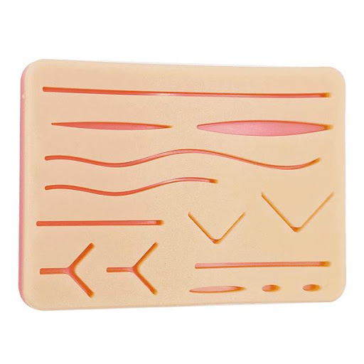 PAD DE SUTURA GMD GMD  x 1 Pad de silicona con tres capas que simulan la piel, grasa y músculo, diseñado para la práctica de suturas en estudiantes y profesionales de la salud. Su textura realista permite entrenar técnicas quir